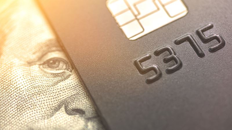 debit card laying on cash