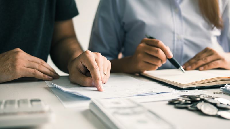 two people looking a documents