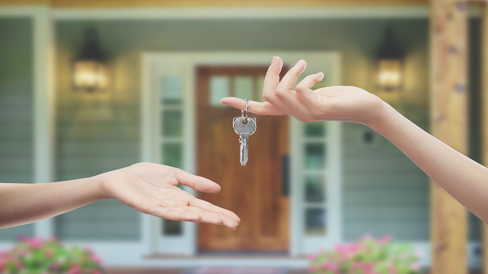 person handing keys to another person
